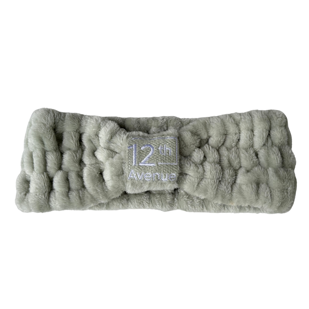 Gray textured headband with a brand label on a white background