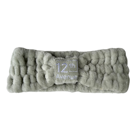 Gray textured headband with a brand label on a white background